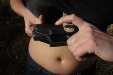 Slide the rear in while the gun's pointed away from you and others.