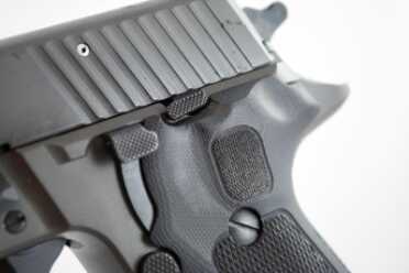 The slide stop lever and decocking lever are lower profile, smaller, and have a checkering pattern.