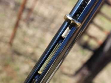 This tab will slides down the tube and keeps spring pressure on the rounds.