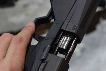 The fixed barrel means that the slide rockets back on these two guide rods. 