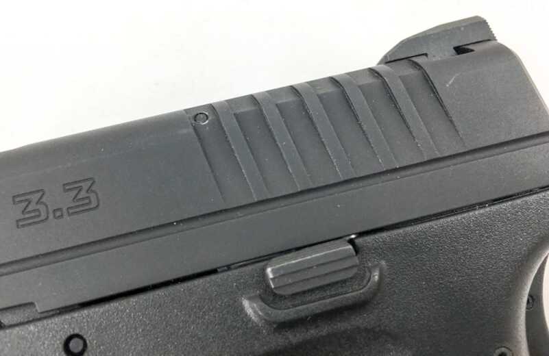 Cocking serrations are on the rear of the slide only.