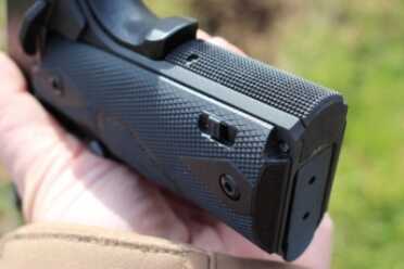 New Gun Review: Springfield 1911, Loaded Parkerized with Crimson Trace The switch that turns the laser grips on.