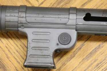 Magazine well for holding on to. Button is magazine release.