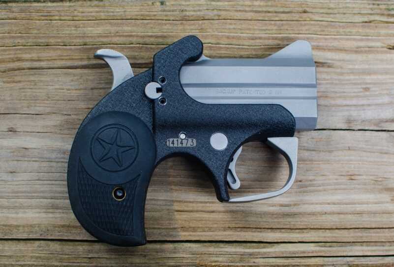 The Bond Arms Backup is a compact derringer with a matte-black and stainless steel finish.
