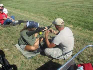 AMU Instructors give guidance to a shooter during the Small Arms Firing School.
