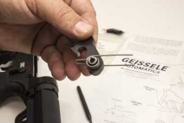 STEP 5: Install hammer pin retainer onto cutout on right side of hammer. Make sure the hammer spring is installed correctly on the hammer. The spring legs are toward the hammer strike face and away from hammer sear. It is possible to install the hammer spring backwards so this must be checked by comparing with the picture of the hammer spring in the instructions.