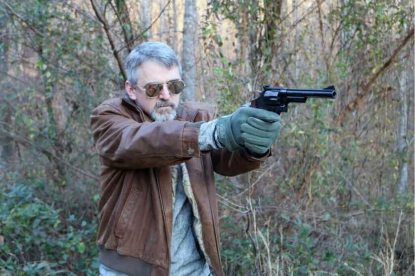 Dr. Dabbs - Bella Twin: The Tiny Little Woman and the Really Big Bear Man in leather jacket shooting the S&W Model 29.44 Magnum handgun in the woods