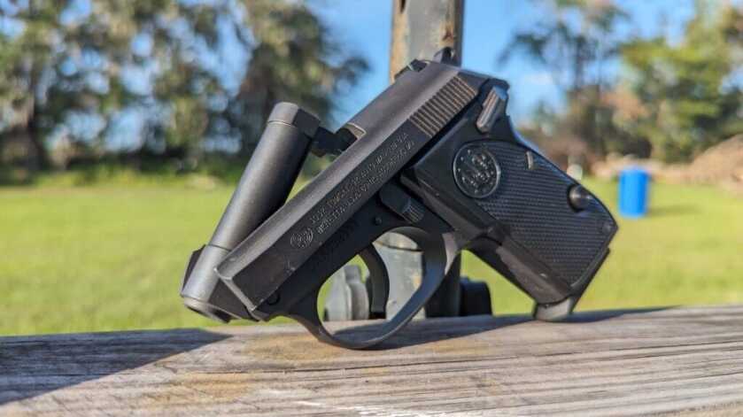 The Beretta Tomcat with barrel tipped up outside on wooden platform