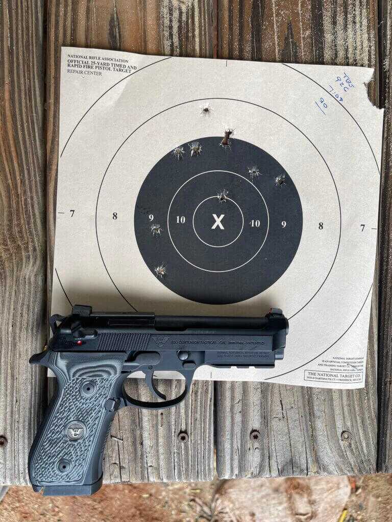 Wilson Combat Beretta 92G with target on aged wooden table