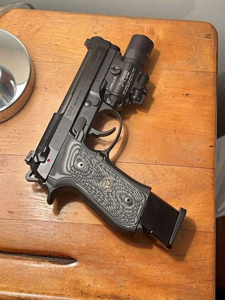 Wilson Combat Beretta 92G with the Surefire X400 and an extended magazine on a bedside table