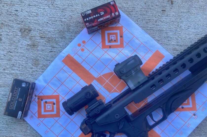 KelTec R50 sitting on target sheet with ammunition