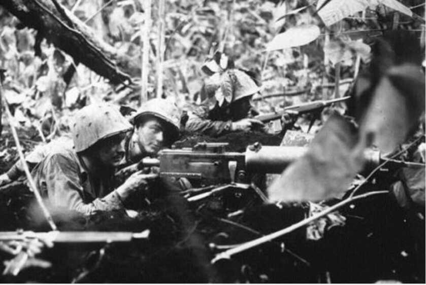 black and white photo of soldiers shooting an M1917 water-cooled machine gun 
