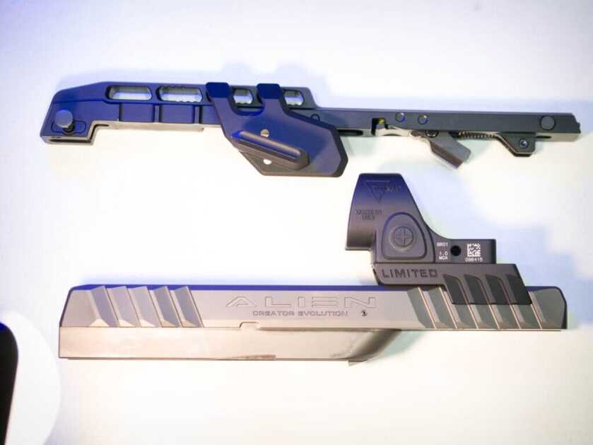 The slide and top rail from the LO Kit are laid on the table.