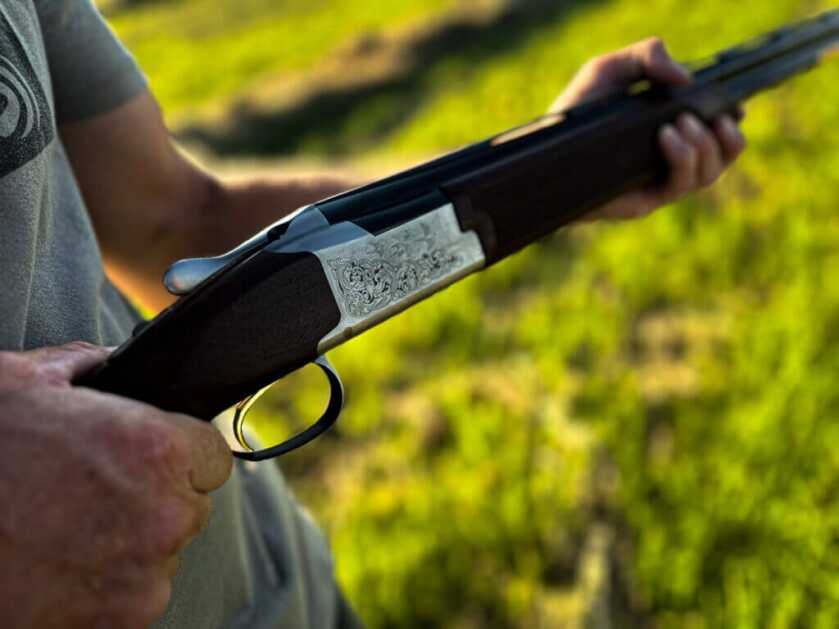 man holding Citori 725