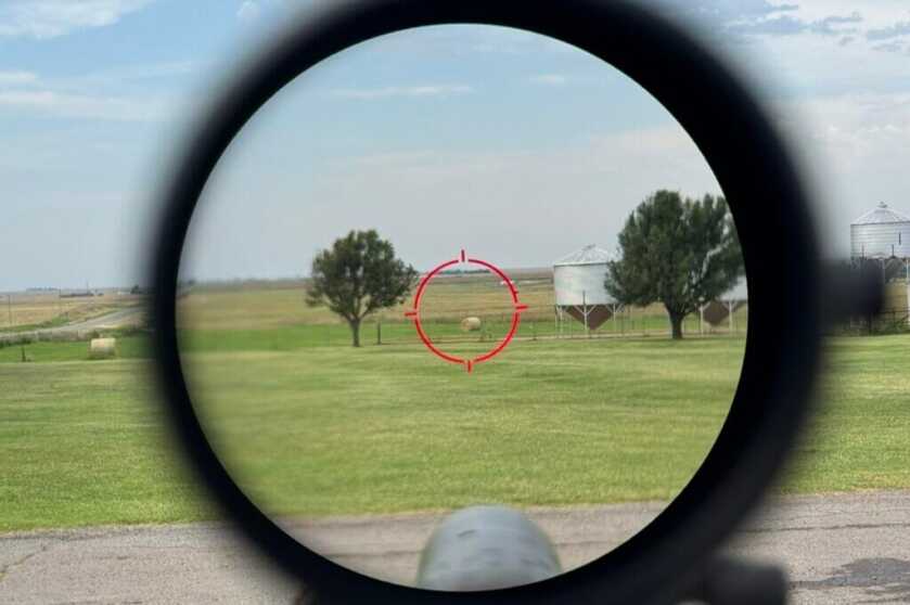 Looking through scope reticle at field