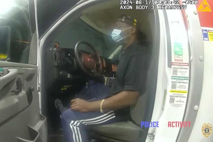 The suspect sits in the driver's seat of the U-Haul.