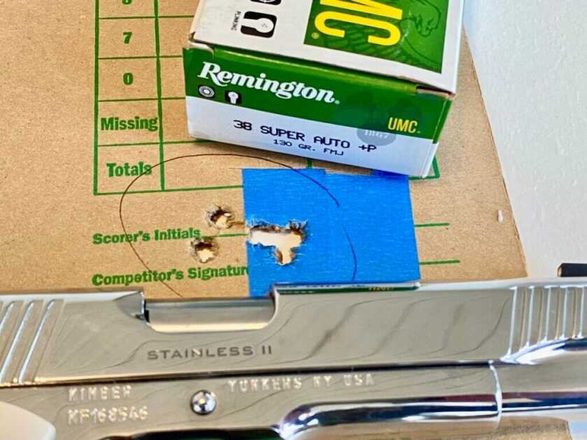 Shiny silver handgun on target with Remington ammo