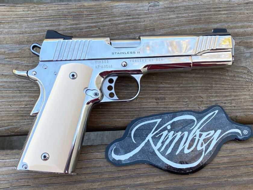 Kimber Stainless II 1911 with Kimber patch on wooden table