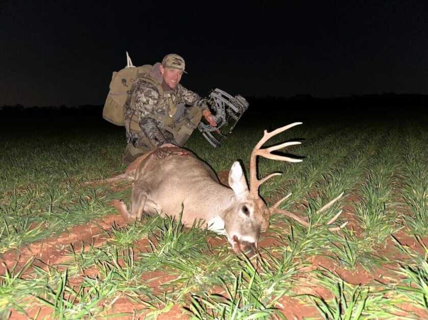 hunter with buck and Hoyt Alpha X 33 bow