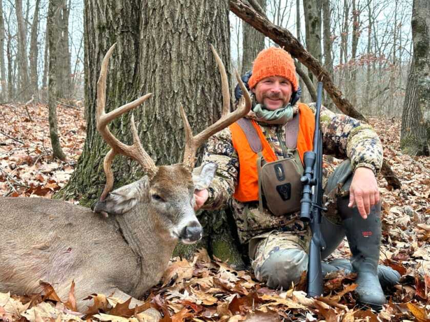 The author, the Winchester rifle, and the drop-tine buck.