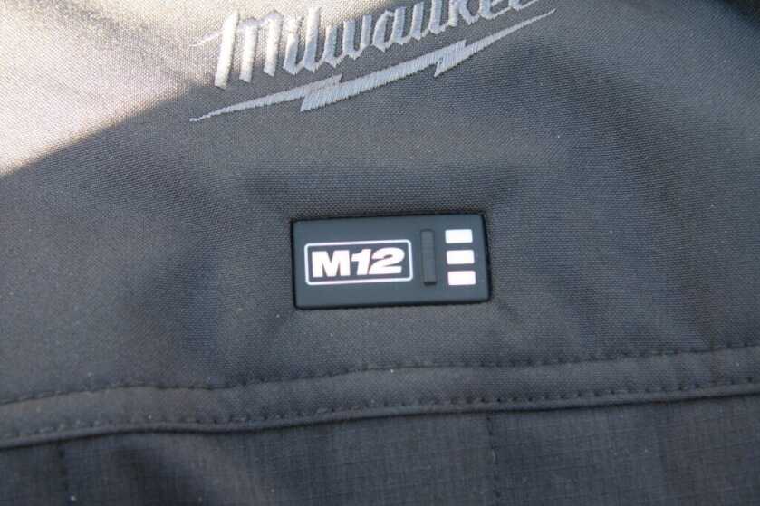 Milwaukee M12 Axis vest rubberized power button with high medium low light indicators