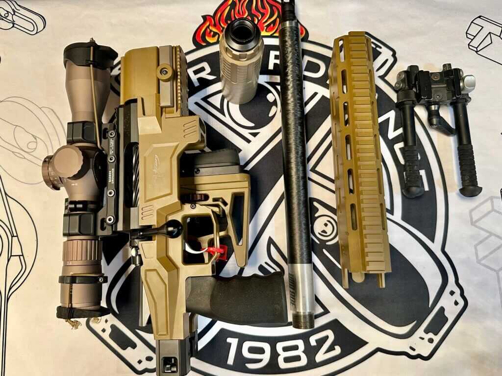 A rifle is taken apart into multiple pieces. It is designed to fit like this inside a laptop case.