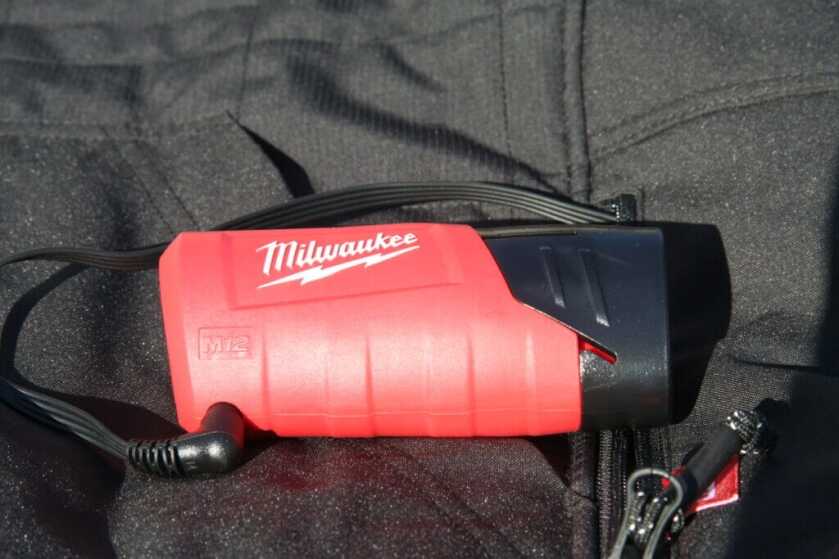 M12 battery seated in Milwaukee Axis vest pocket via battery holder