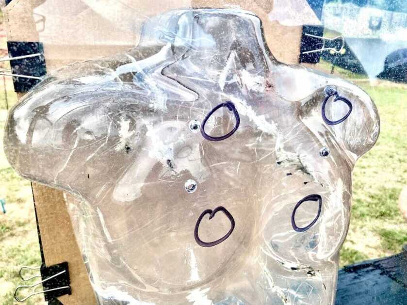 Torso shaped ballistic gel with circles drawn in marker to show where bullets penetrated