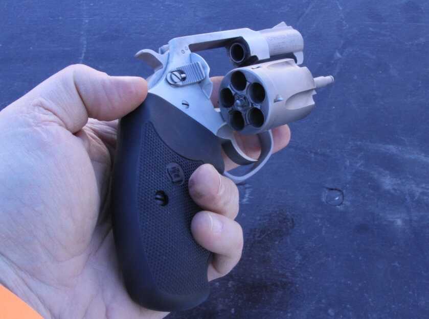 Man holding a revolver left-handed