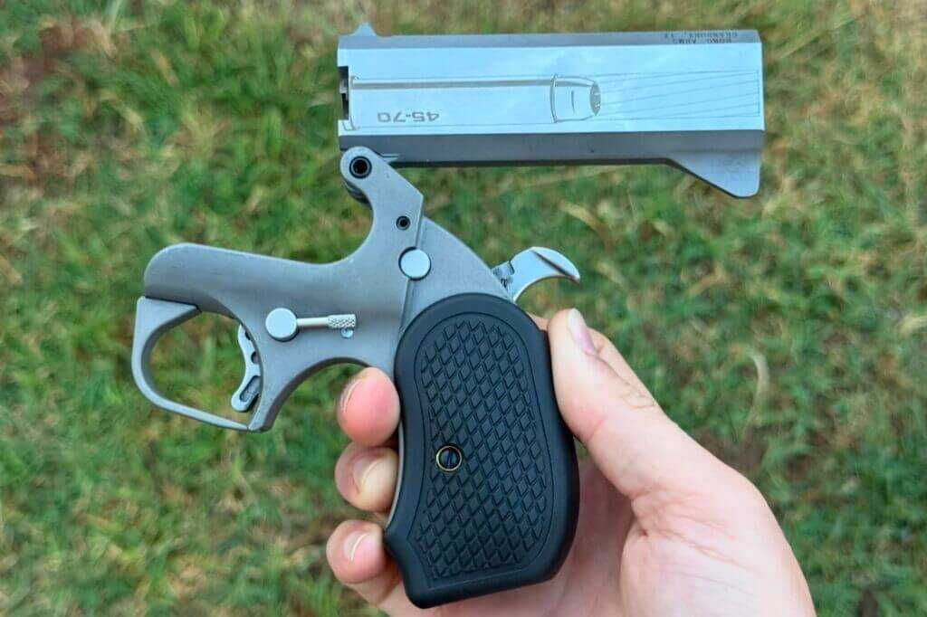 The handgun barrel hinges on the rear sight which is machined to be part of the barrel