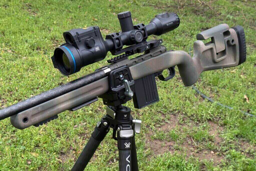 Vortex Pro Rifle Clamp Tripod Mount with rifle and scope on green lawn