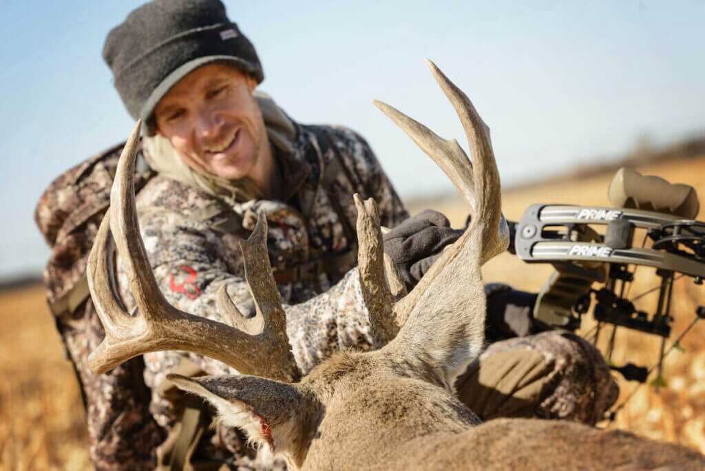 man with dead deer