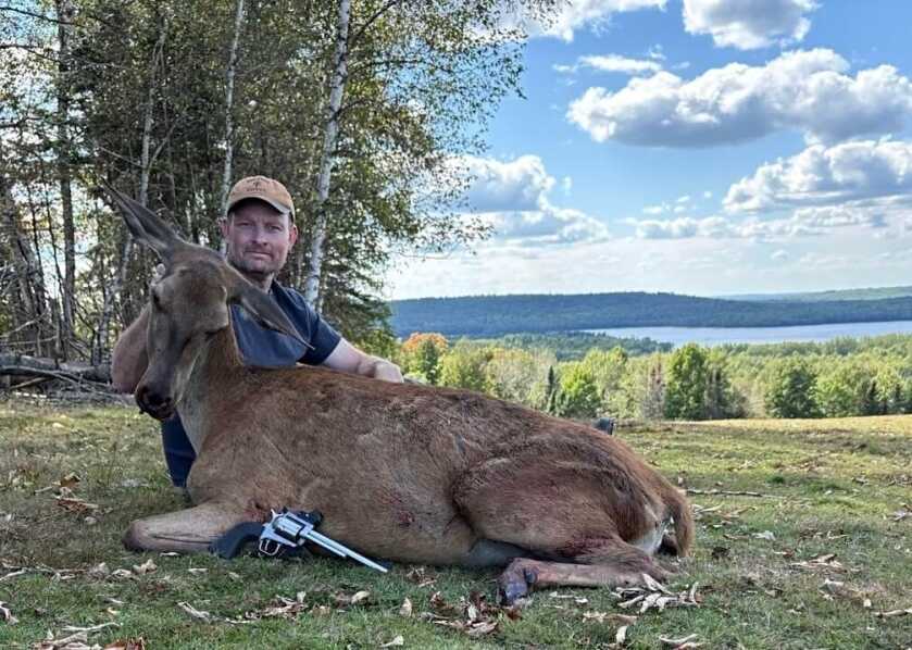 Hunter with bear and red deer taken using a 454 Casull and 260gr Winchester Partition Gold