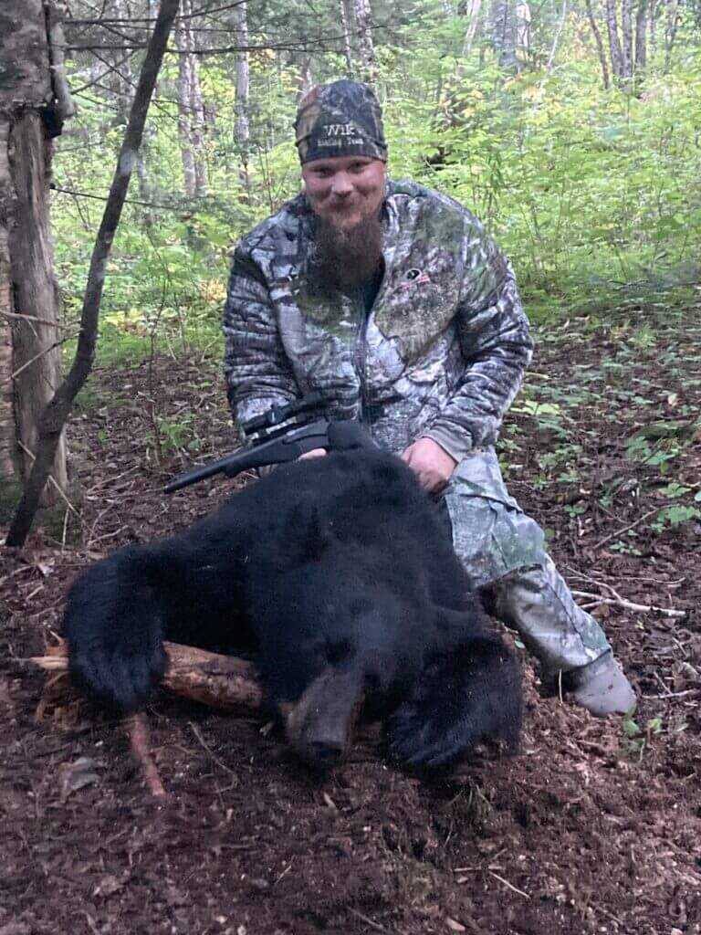 Hunter Adam with his successful handgun black bear taken in Maine
