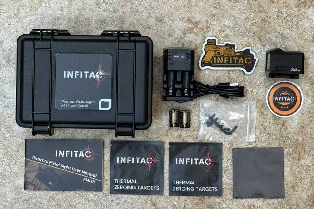 Infitac FML19 full kit laid out with RMR adapter, charger, CR2 batteries, tools, and zero targets