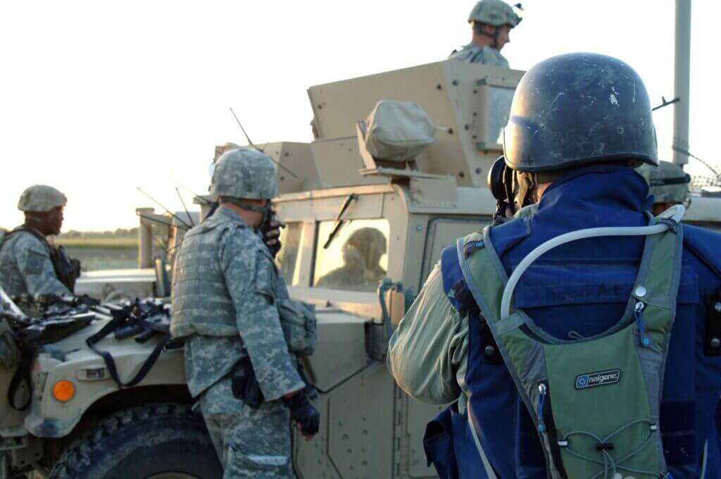 Embedded reporter with military unit in combat zone illustrating battlefield media concerns