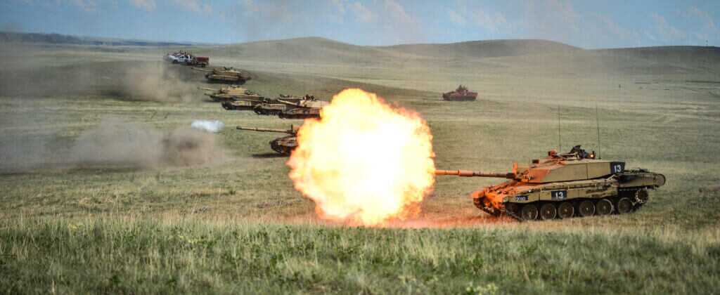 Challenger 2 tank firing during urban breaching demonstration echoing British assault tactics in Basra