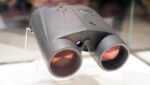 Front view of the binoculars on a stand, looking into the objective lens.