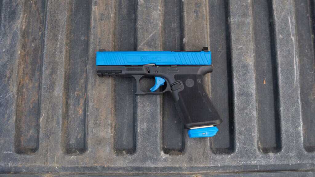 Unit 9 Compact blue slide Glock 19-style training pistol with realistic weight and controls