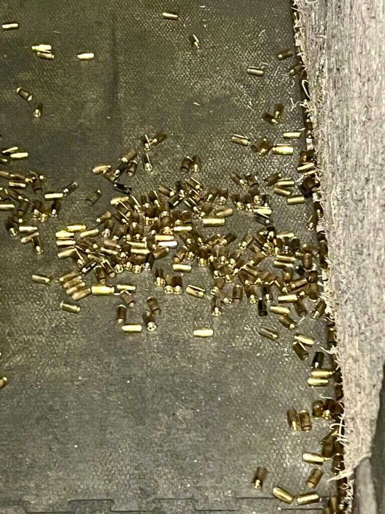 Range floor covered in spent brass showing false lead concerns in gun microstamping investigations