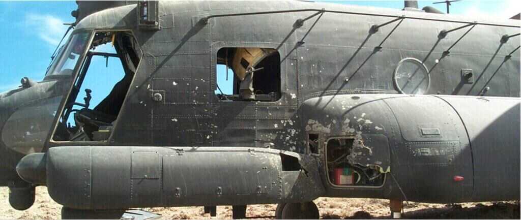 Damaged MH-47E Chinook 476 showing heavy combat damage from automatic weapons and RPG fire