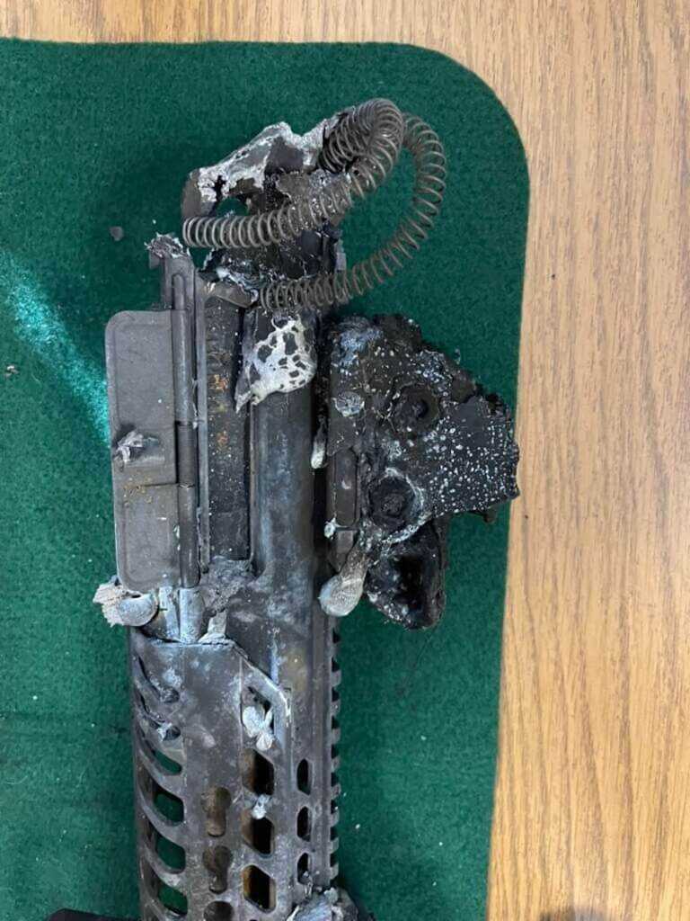 Burned and melted components from Officer Vincent Li’s SIG MCX rifle following the patrol vehicle fire.