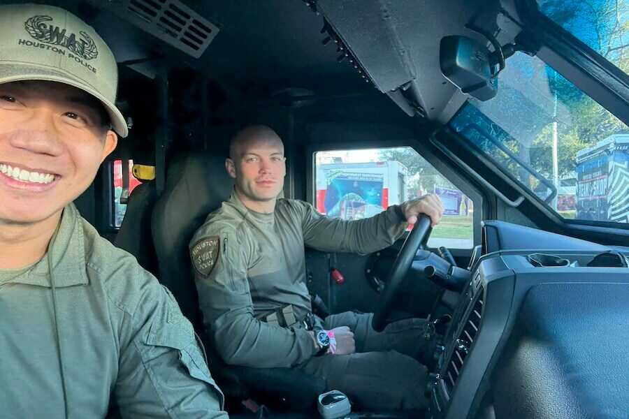 Two Houston Police SWAT officers sit inside an armored vehicle before operations during a later stage of Vincent Li’s law enforcement career.