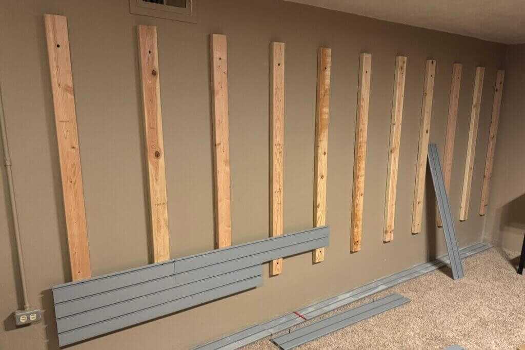 Hold Up Displays metal slats being screwed onto installed 2x4 studs in a safe room