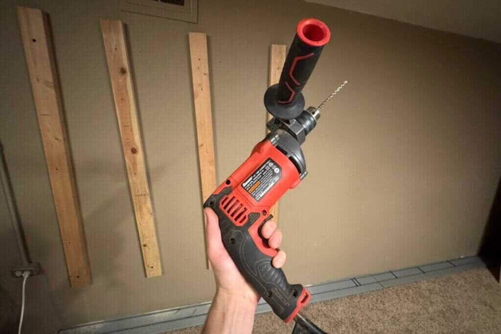 Rotary hammer drill used to mount a Hold Up Displays Gun Wall onto a concrete safe-room wall