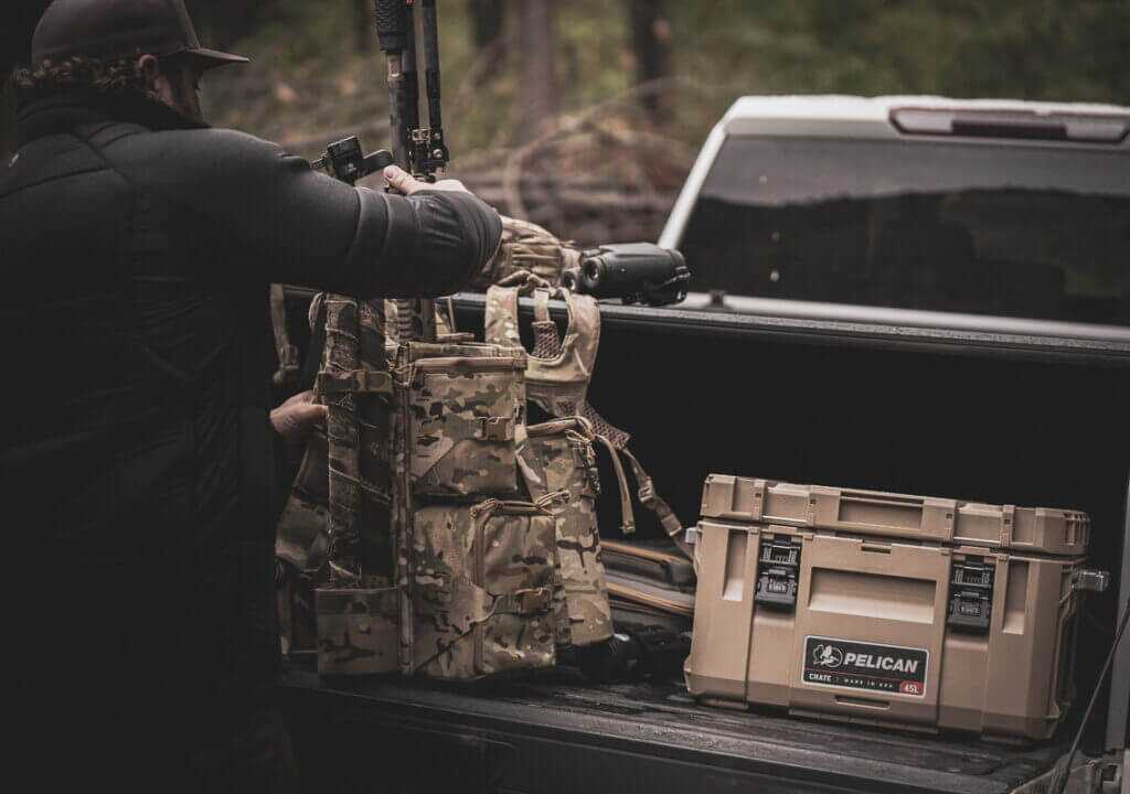 Pelican CRATE 45L waterproof gear case keeping expensive range and hunting gear dry in a rainy truck bed