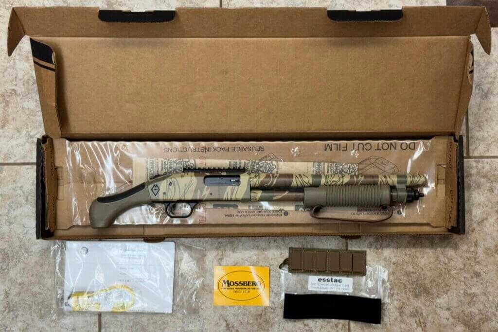 Mossberg 590 Bliksem factory contents with Esstac 6-round shell carrier, manual, lock, and sticker