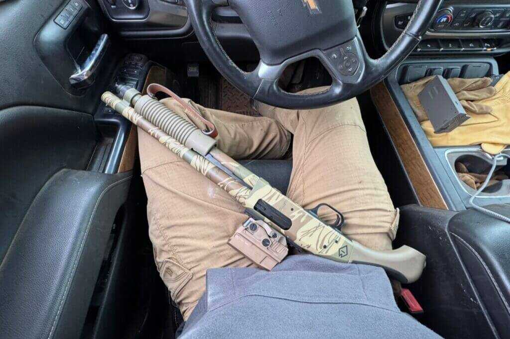 Mossberg 590 Bliksem fitting across the shooter’s lap in a compact vehicle space
