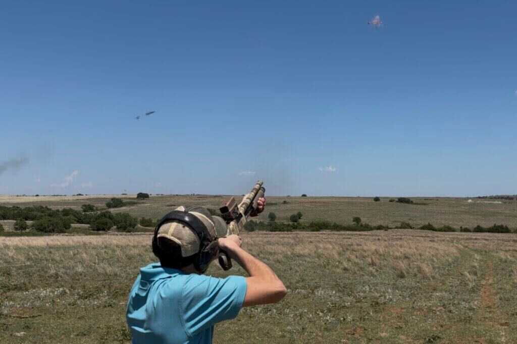 Mossberg 590 Bliksem breaking skeet during practical range testing with compact 12-gauge setup