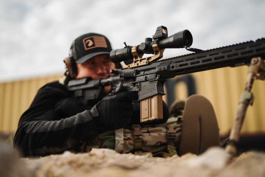 Shooter fires a Primary Weapons Systems MK2 MOD 2-M .308 rifle equipped with a riflescope at an outdoor range.